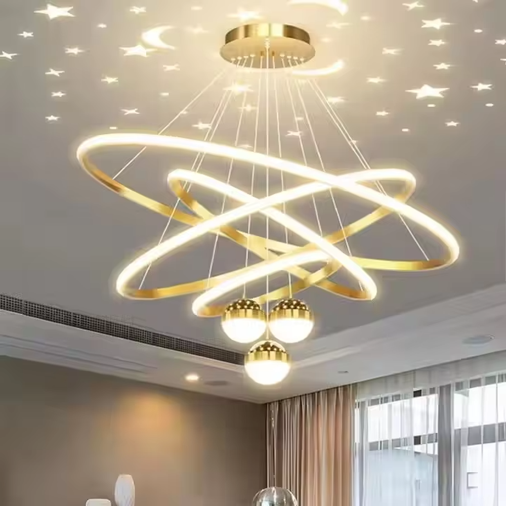 This is a modern creative cross-ring starry sky projection chandelier, with a black frame paired with cross-ring light strips and spherical lamps, and a starry sky (star and moon) projection function. The design is modern and dreamy, with soft lighting and a strong atmosphere. It is used for space lighting and atmosphere creation, suitable for modern-style living rooms, children's rooms, light luxury-style bedrooms and other places.