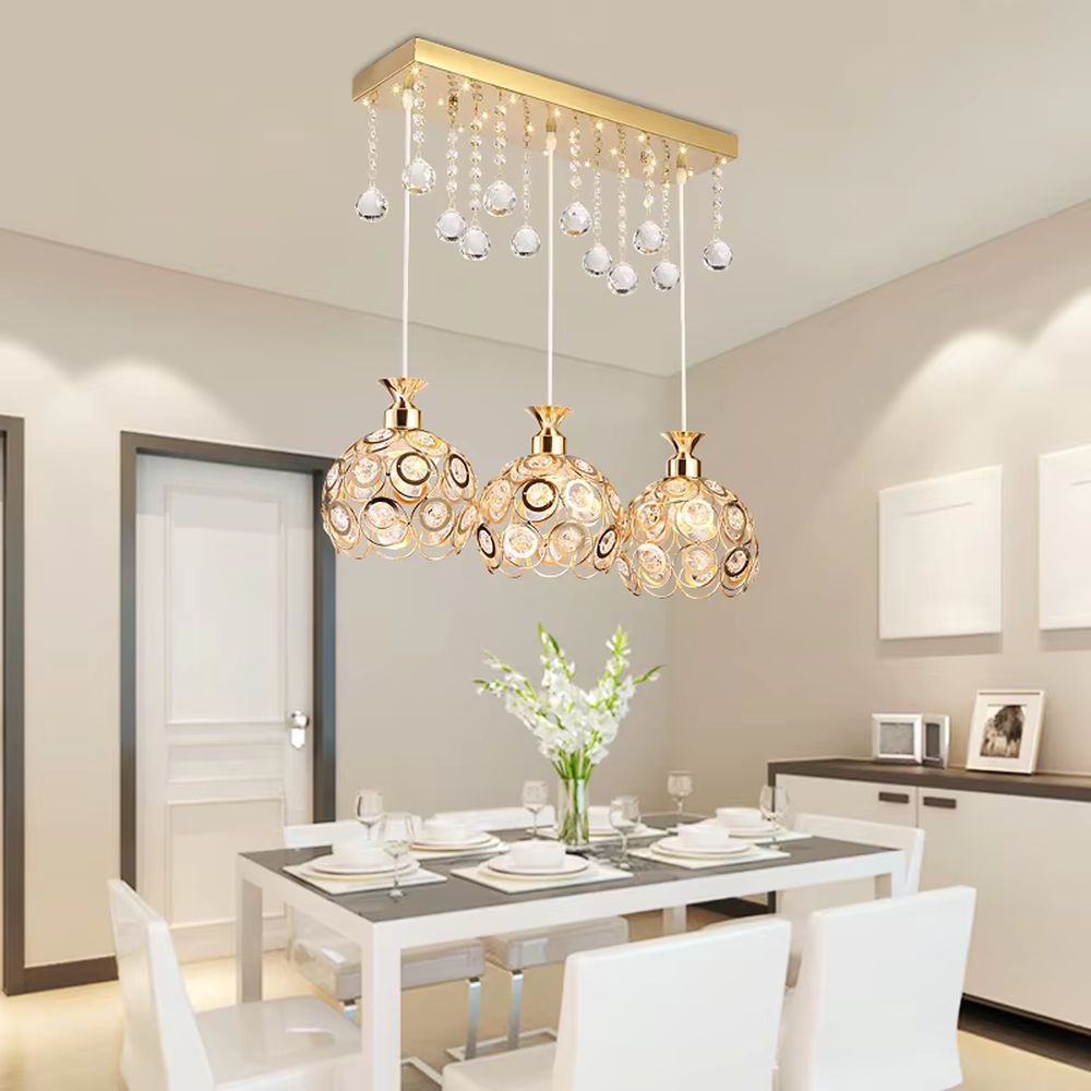 This light luxury three-head dining chandelier features a black metal top frame, paired with silver suspension rods and hollow black-gold spherical lampshades (embedded with crystal accents), with an exquisite and brilliant shape, serving both lighting and decorative purposes, ideal for dining rooms, bars, light luxury homes and other scenarios.