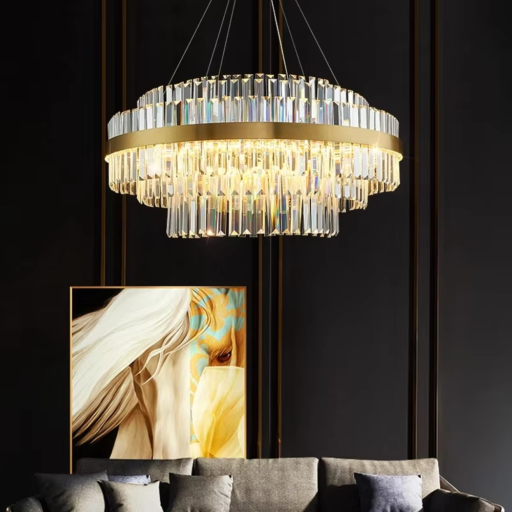 This is a light luxury style multi-layer circular crystal chandelier, featuring a gold metal frame paired with transparent cut crystal strips. The light refracts through the crystals to create a brilliant and luxurious lighting effect, serving both lighting and decorative purposes, and is suitable for quality-focused scenarios such as villa living rooms, duplex high-ceiling spaces, hotel lobbies, and high-end restaurants.