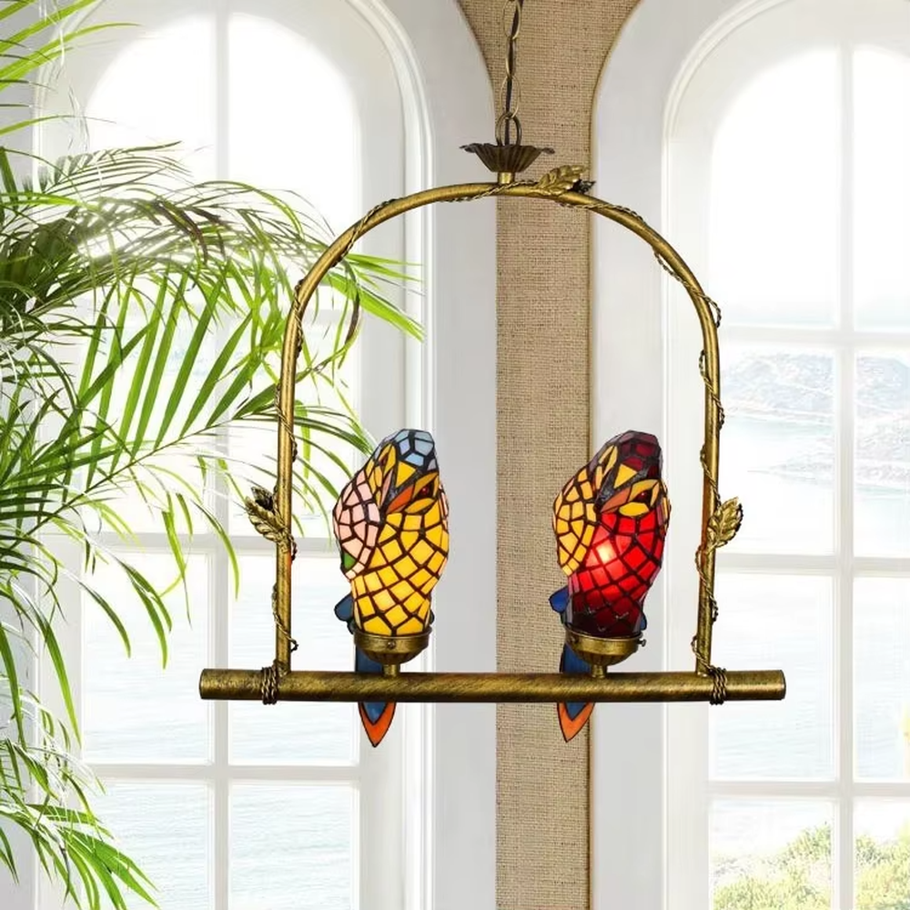 This is an artistic chandelier with a golden metal frame and two parrot - shaped colored glass lamp bodies, which are vivid and unique, full of childlike fun and artistic sense. It is used for both lighting and decoration, adding personality and vitality to the space through the unique parrot shape. It is suitable for themed restaurants, characteristic homestays, art cafes, children's rooms and other places.