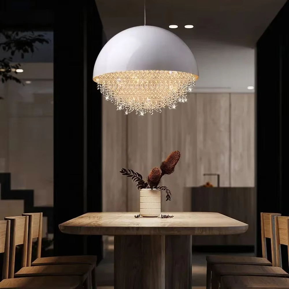 This modern light luxury hemispherical chandelier features a white metal upper cover, with dense crystal decorations along the lower edge like a falling waterfall. It serves both lighting and decorative purposes, ideal for dining rooms, living rooms, light luxury commercial spaces and other scenarios.