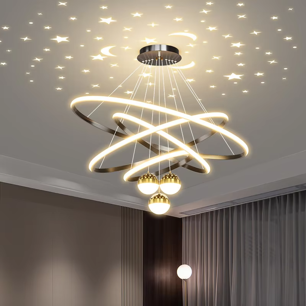 This modern light luxury galaxy-shaped chandelier features multi-layer interlaced ring light strips made of gold metal, paired with spherical crystal lamp shades, and has a built-in starry sky projection effect on the top. It serves both lighting and decorative purposes, ideal for modern home spaces such as living rooms and dining rooms, as well as light luxury commercial venues.