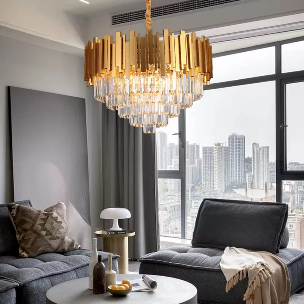 This is a luxurious modern-style golden column crystal chandelier, with a golden metal column structure and transparent crystals, featuring a grand and luxurious design, brilliant lighting. It is used for space lighting and decoration, creating a high-end luxurious atmosphere. Suitable for luxury villa living rooms, high-end hotel lobbies, light luxury-style restaurants and other places.