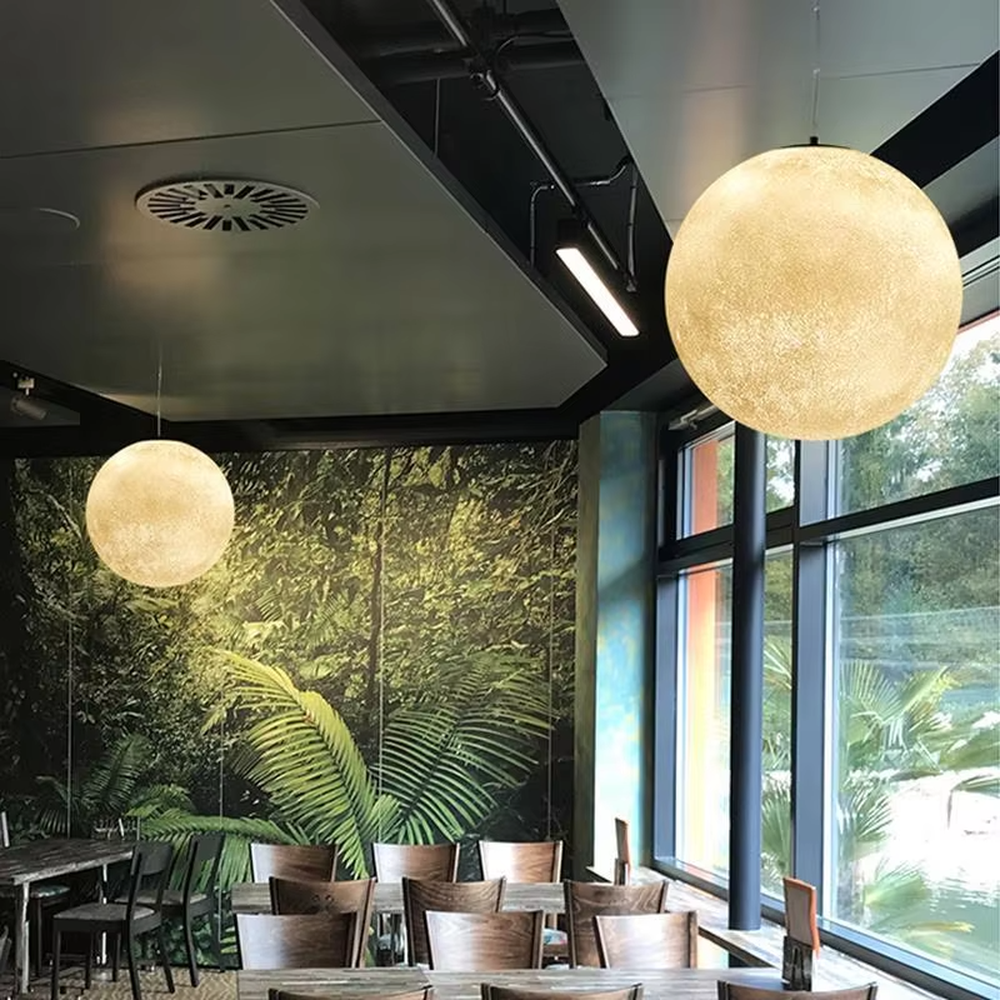 This moon-shaped chandelier simulates lunar surface texture with soft light-transmitting material, hung in varying sizes, serving both lighting and decorative purposes, ideal for Internet celebrity restaurants, cafes, office spaces, exhibition halls and other scenarios.