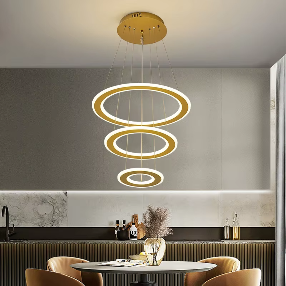 This is a modern minimalist three-layer circular hanging chandelier, featuring a multi-layer hanging design with white circular light strips. It has a simple and grand style, with soft and uniform lighting. It is used for space lighting and decoration to create a minimalist modern atmosphere. Suitable for modern kitchen dining areas, minimalist living rooms, modern apartment dining areas and other places.