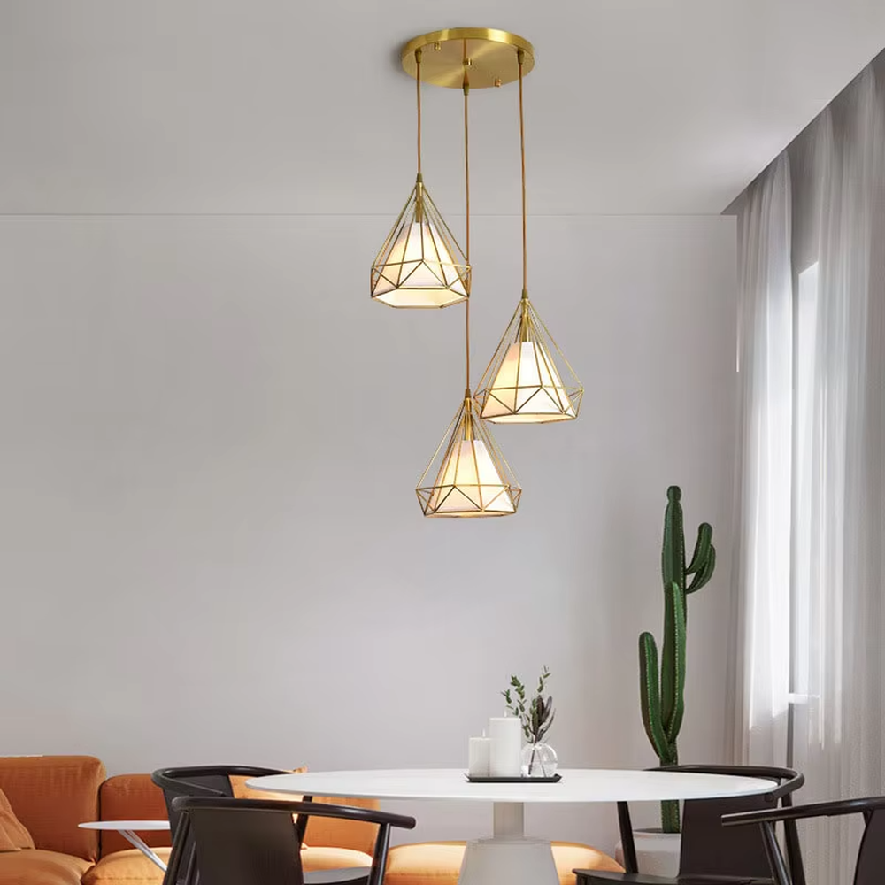 Light luxury geometric diamond triple chandelier (gold metal frame + translucent lampshade), warm light effect, creating a stylish and exquisite space atmosphere.