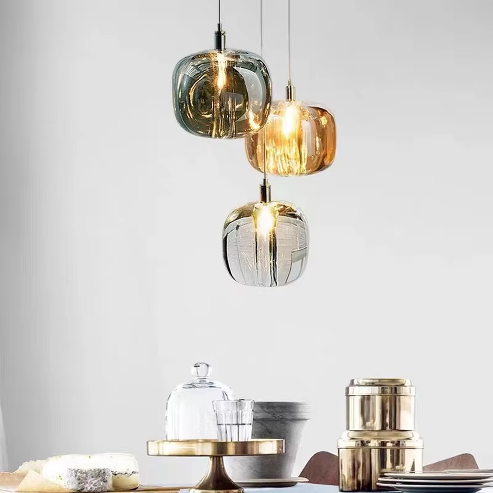 Light luxury multi-color textured glass ball combination hanging lamp, dark green/gold/silver textured glass balls + thin suspension ropes, warm light refracts a flexible texture, creating a light luxury artistic atmosphere.