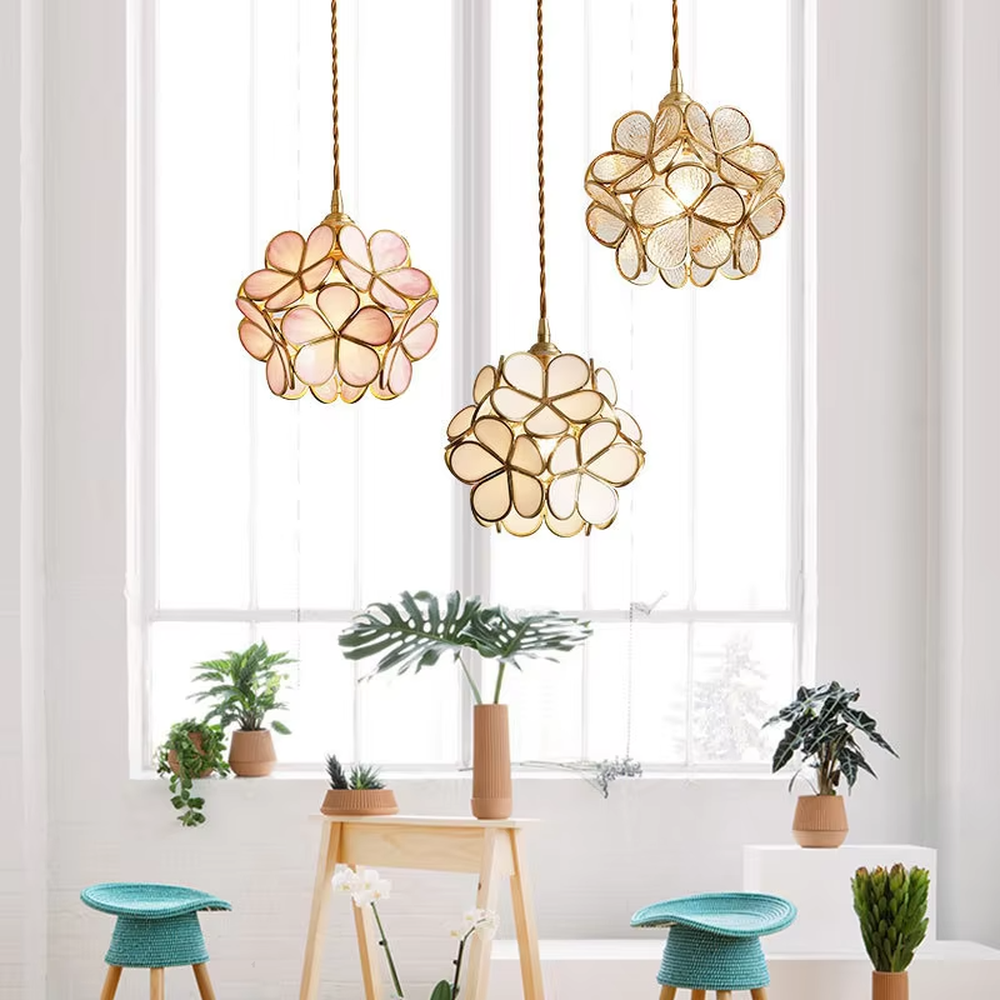 Retro light luxury petal spherical chandelier, golden metal petal frame + textured transparent glass panels + jute rope hanger, soft warm light with textured light and shadow, creating a warm artistic atmosphere.
