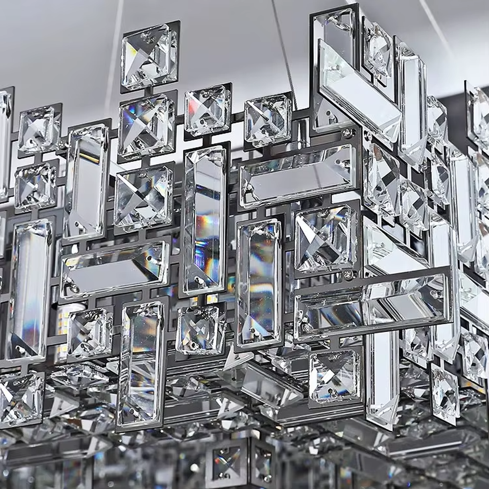 This is a modern luxurious rectangular crystal block combination chandelier, composed of a large number of transparent cut crystal blocks irregularly spliced into a rectangular shape, paired with a metal frame. The light through the crystals is brilliant and bright, creating a high-end modern luxurious atmosphere.