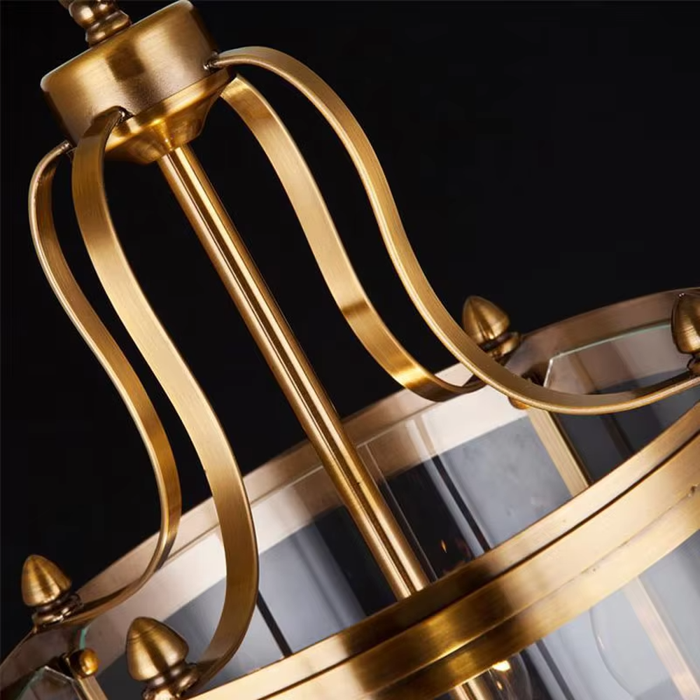 Light luxury golden metal cage-style cylindrical glass cover candelabra chandelier, golden frame + transparent cylindrical glass cover + candle-shaped bulbs, soft warm light, suitable for modern minimalist dining area atmosphere.