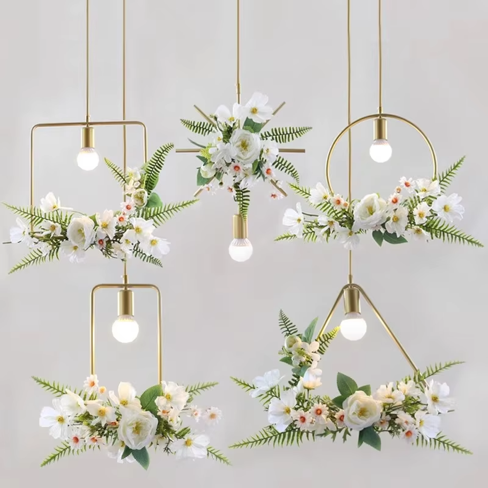 This is a natural and fresh floral metal chandelier, including two styles of golden circular and radial metal frames, paired with artificial green plants, flowers and transparent bulbs. It features a natural and romantic design with warm and soft lighting. It is used for space lighting and decoration, creating a natural and romantic atmosphere. Suitable for Nordic-style homes, literary cafes, wedding venues, art homestays and other places.