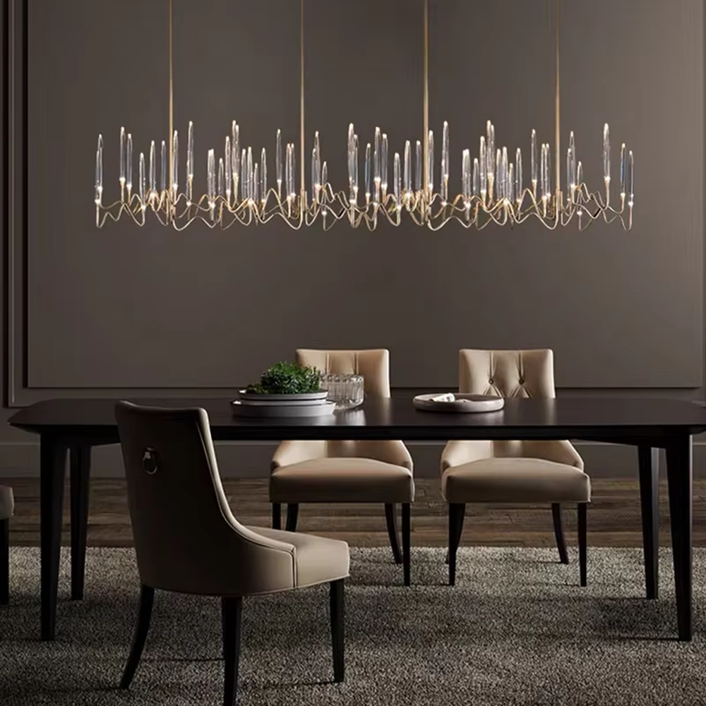 This is a modern artistic luxury chandelier, with a golden metal curved frame and transparent glass tube - shaped lampshades, featuring artistic layers and strong luxury sense. It is used for space lighting and decoration, creating an artistic luxury atmosphere. It is suitable for high - end restaurants, modern luxury home living rooms, art soft decoration spaces and other places.