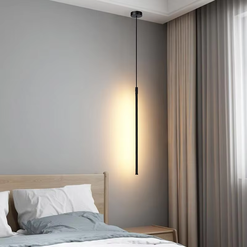 This minimalist linear chandelier features a slender black metal lamp body with a floating suspension design, emitting soft diffused light, serving both lighting and decorative purposes, ideal for bedroom bedside tables, living room feature walls, modern minimalist homes and other scenarios.