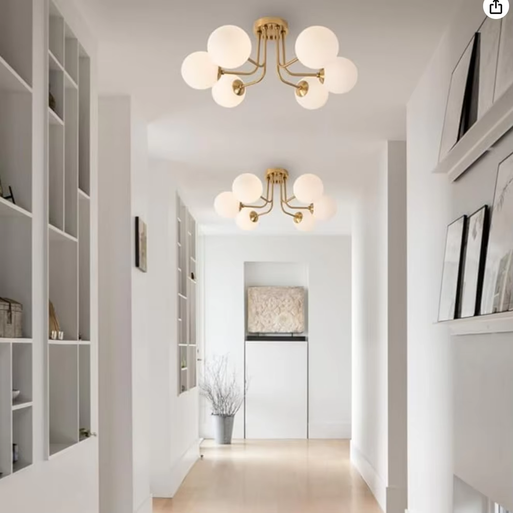 This is a Nordic modern luxury spherical ceiling light, with a golden metal branched stand and multiple white spherical frosted lampshades, featuring a minimalist modern design and strong luxury sense. It is used for space lighting and decoration, creating a warm modern luxury atmosphere. It is suitable for modern luxury home living rooms, Nordic-style bedrooms, designer studios and other places.