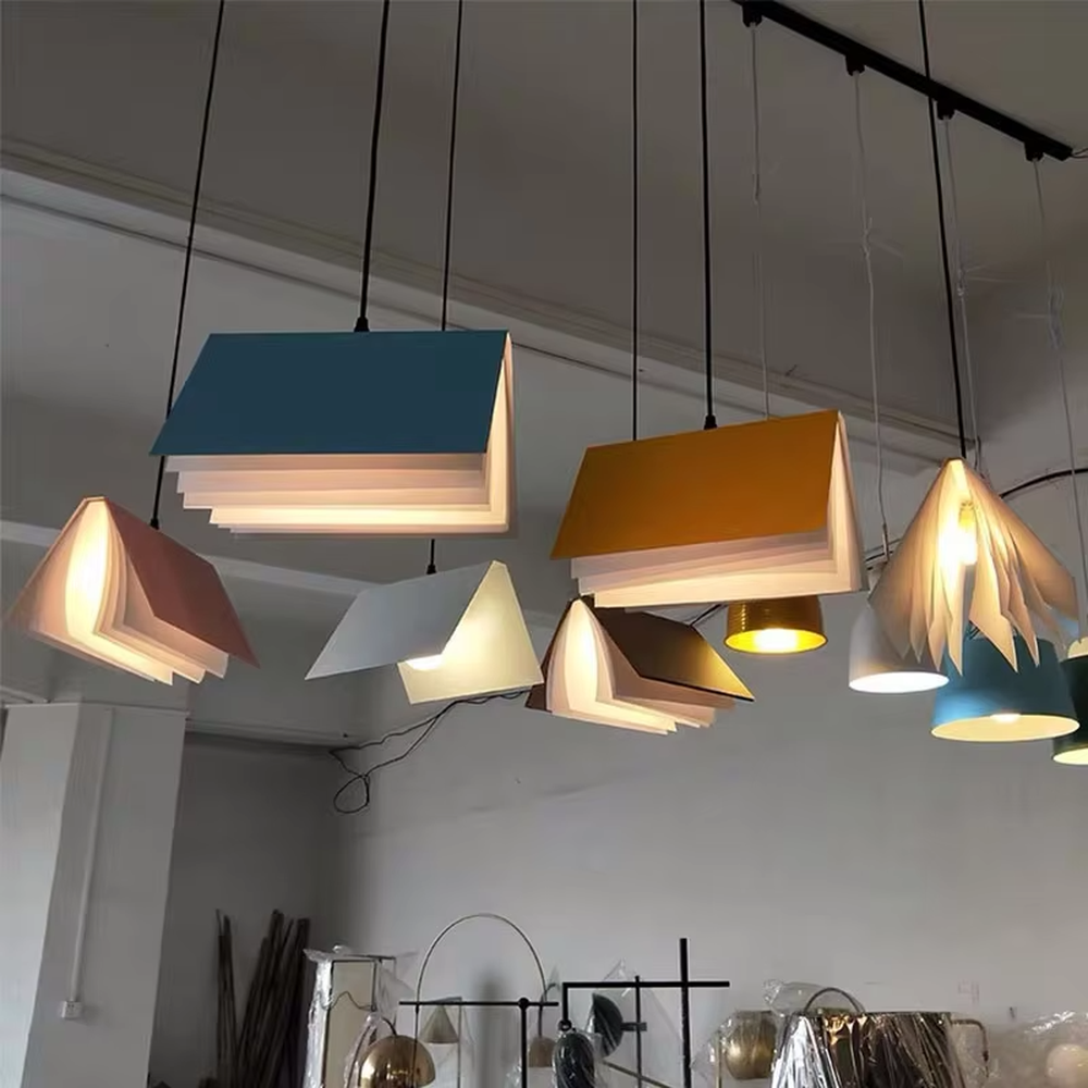 Creative origami book-shaped colorful hanging chandelier, folded structure + multi-color appearance (orange/pink/white/blue, etc.), soft and warm lighting, creating a literary creative atmosphere.
