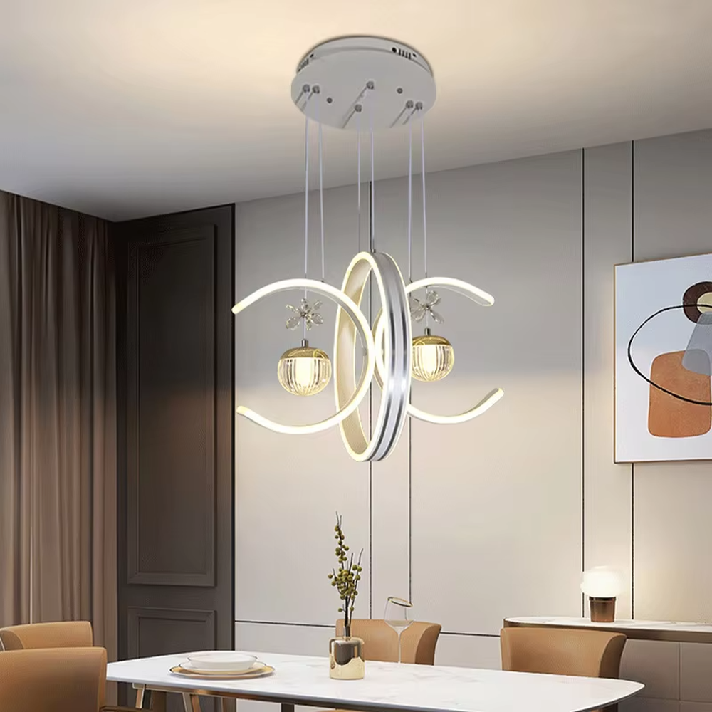 This modern light luxury chandelier features interlaced ring-shaped LED bodies and spherical crystal lamp shades with dragonfly decorations. It has smooth, layered lines, serves both lighting and decorative purposes, and is ideal for modern home spaces like dining rooms and living rooms, as well as light luxury commercial venues.