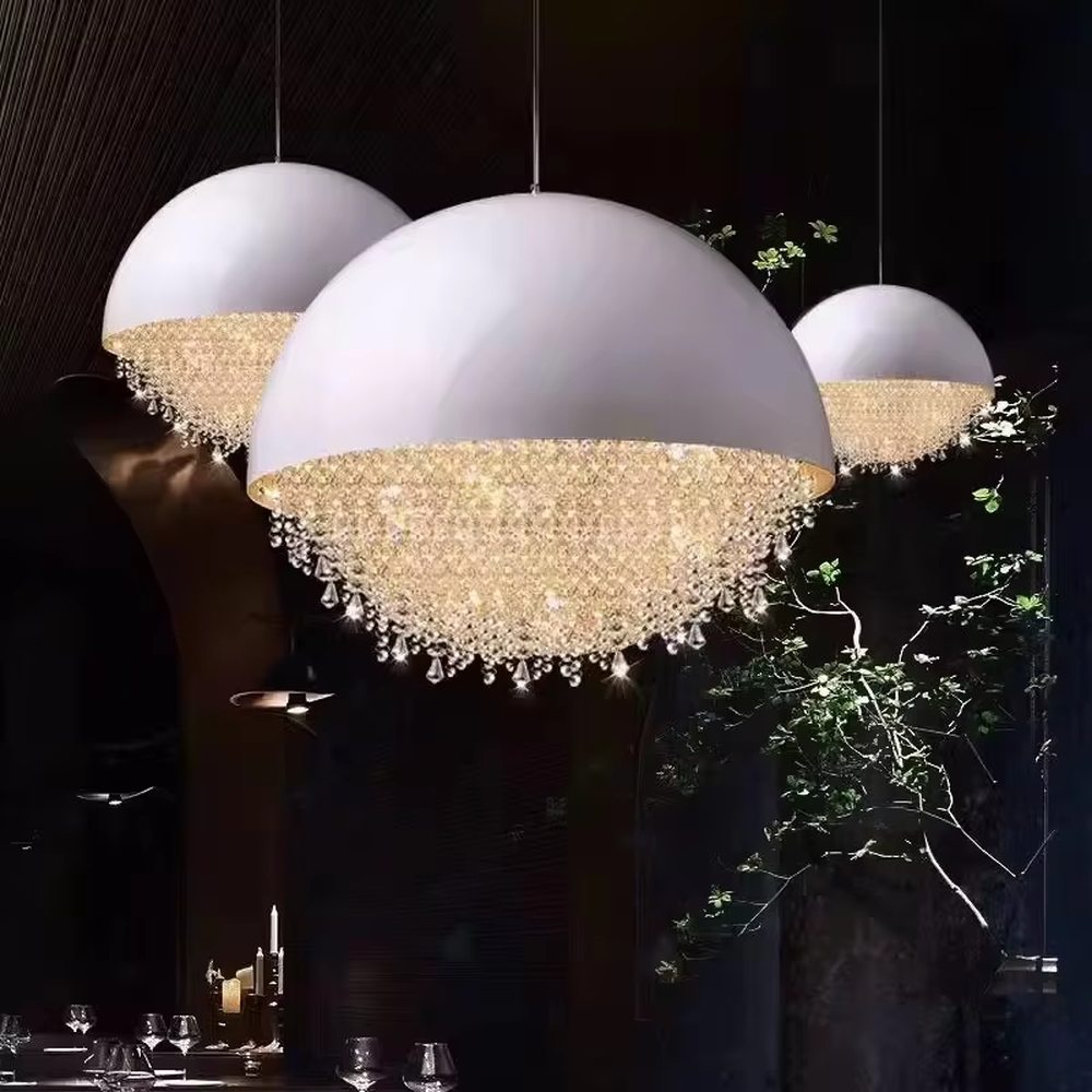 This modern light luxury hemispherical chandelier features a white metal upper cover, with dense crystal decorations along the lower edge like a falling waterfall. It serves both lighting and decorative purposes, ideal for dining rooms, living rooms, light luxury commercial spaces and other scenarios.