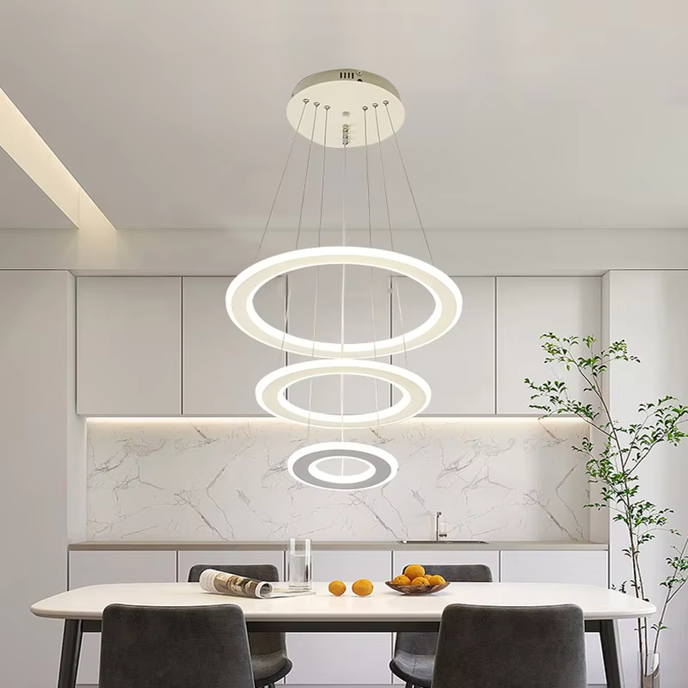This is a modern minimalist three-layer circular hanging chandelier, featuring a multi-layer hanging design with white circular light strips. It has a simple and grand style, with soft and uniform lighting. It is used for space lighting and decoration to create a minimalist modern atmosphere. Suitable for modern kitchen dining areas, minimalist living rooms, modern apartment dining areas and other places.