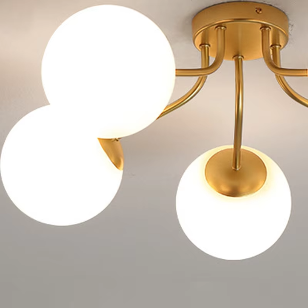 This is a Nordic modern luxury spherical ceiling light, with a golden metal branched stand and multiple white spherical frosted lampshades, featuring a minimalist modern design and strong luxury sense. It is used for space lighting and decoration, creating a warm modern luxury atmosphere. It is suitable for modern luxury home living rooms, Nordic-style bedrooms, designer studios and other places.