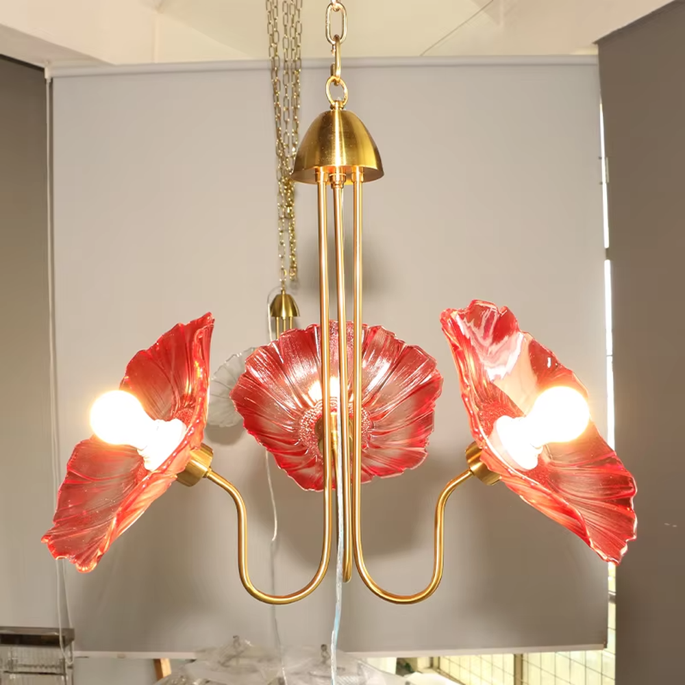 This is an artistic flower-shaped chandelier with a golden metal frame and red glass flower lampshades, featuring a retro luxury design with strong artistic sense. It is used for space lighting and decoration, creating an artistic luxury atmosphere. It is suitable for luxury-style home living rooms, art restaurants, soft decoration display spaces and other places.