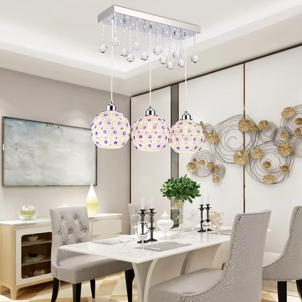 This light luxury three-head dining chandelier features a black metal top frame, paired with silver suspension rods and hollow black-gold spherical lampshades (embedded with crystal accents), with an exquisite and brilliant shape, serving both lighting and decorative purposes, ideal for dining rooms, bars, light luxury homes and other scenarios.
