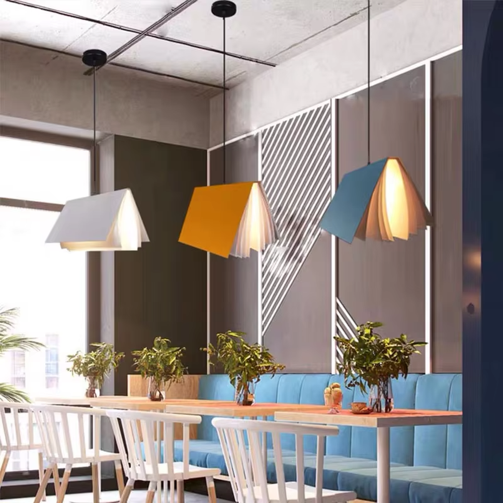 Creative origami book-shaped colorful hanging chandelier, folded structure + multi-color appearance (orange/pink/white/blue, etc.), soft and warm lighting, creating a literary creative atmosphere.