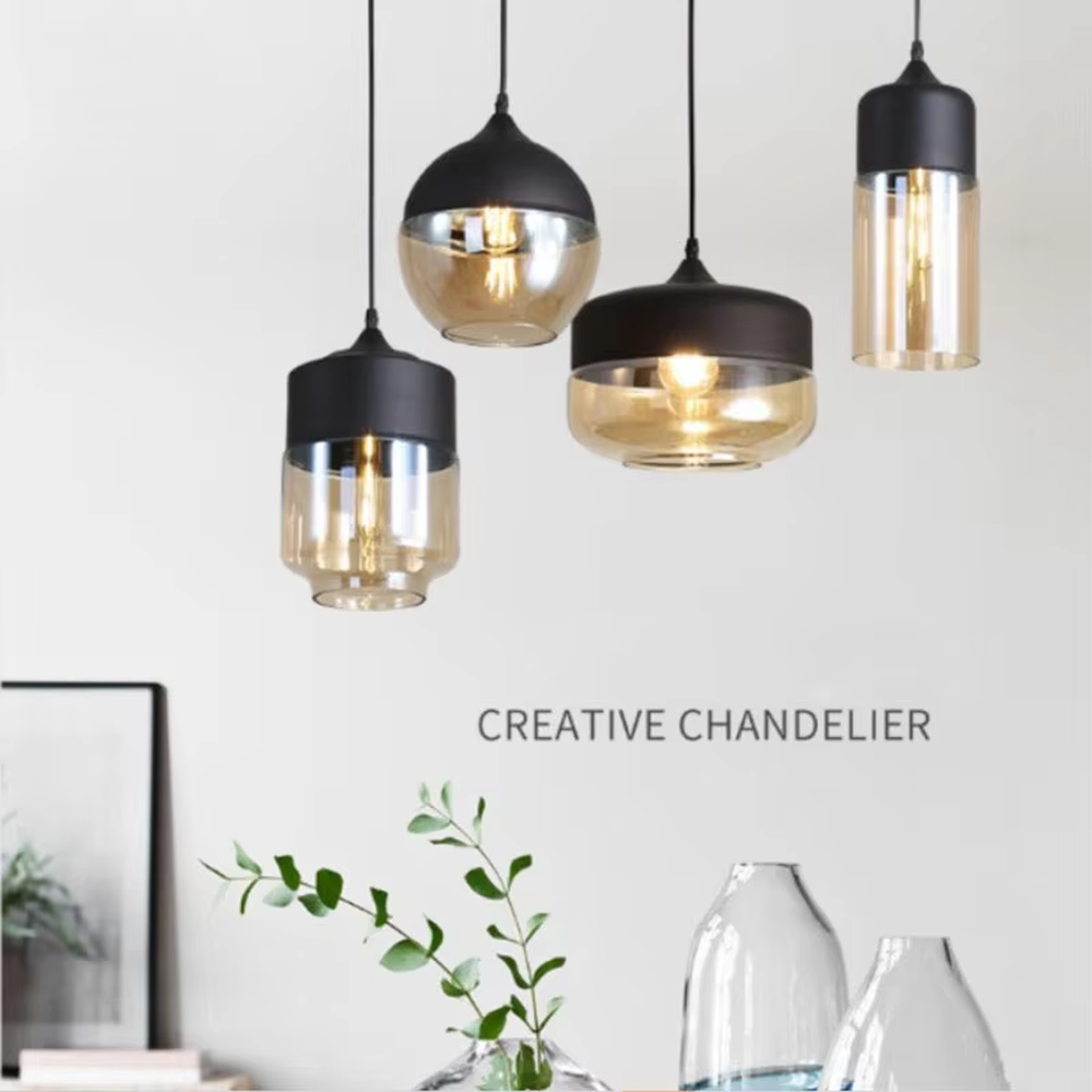 This set of Nordic-style creative small chandeliers features black metal top covers paired with amber glass lampshades, with various shapes that can be hung in combination, serving both lighting and decorative purposes, ideal for dining rooms, bars, Nordic-style homes and other scenarios.