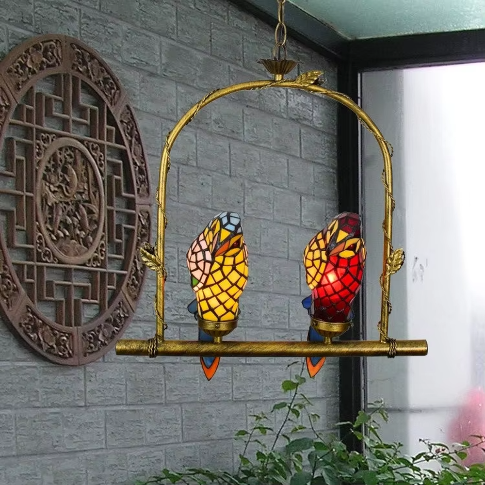 This is an artistic chandelier with a golden metal frame and two parrot - shaped colored glass lamp bodies, which are vivid and unique, full of childlike fun and artistic sense. It is used for both lighting and decoration, adding personality and vitality to the space through the unique parrot shape. It is suitable for themed restaurants, characteristic homestays, art cafes, children's rooms and other places.