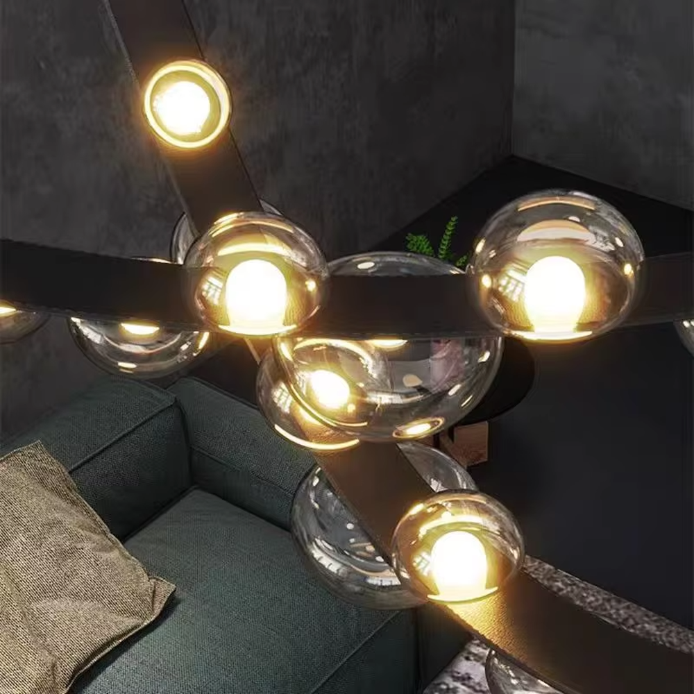 Modern creative curved black frame smoked glass ball chandelier, black curved metal bracket + multiple smoked glass spherical lampshades, soft and high-end lighting, creating a minimalist artistic atmosphere.