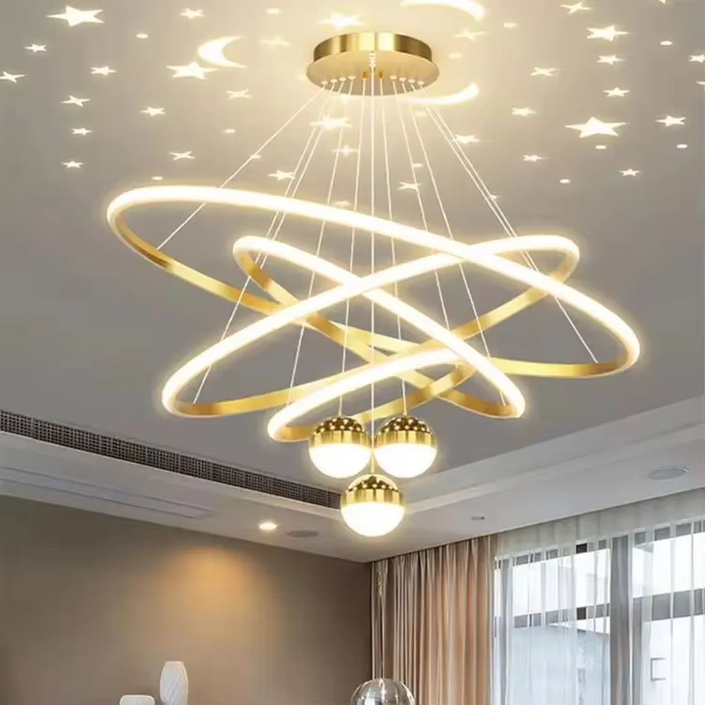 This modern light luxury galaxy-shaped chandelier features multi-layer interlaced ring light strips made of gold metal, paired with spherical crystal lamp shades, and has a built-in starry sky projection effect on the top. It serves both lighting and decorative purposes, ideal for modern home spaces such as living rooms and dining rooms, as well as light luxury commercial venues.