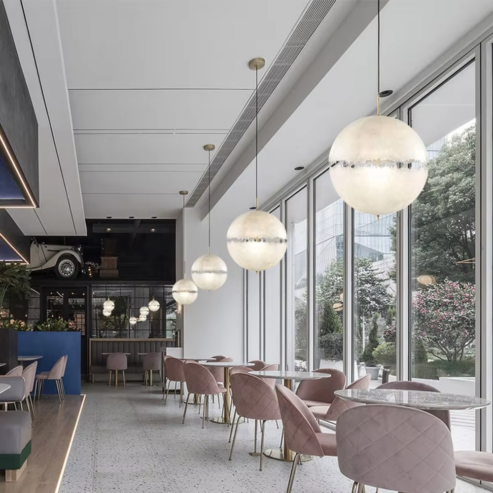 Modern art-style multi-head frosted spherical chandelier, water-textured white shade + black-gold decoration + warm light effect, creating a fresh artistic atmosphere in public spaces.