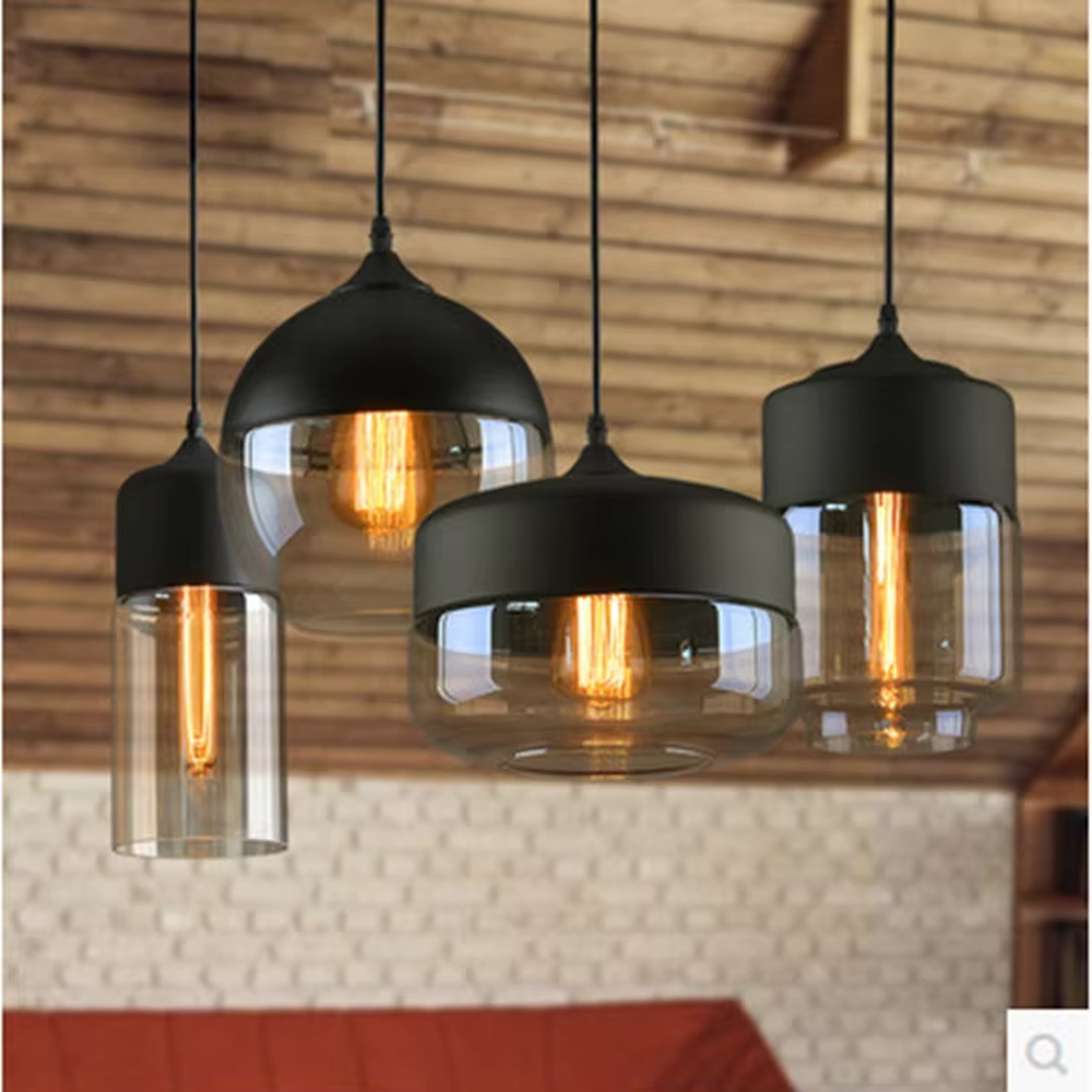 This set of Nordic-style creative small chandeliers features black metal top covers paired with amber glass lampshades, with various shapes that can be hung in combination, serving both lighting and decorative purposes, ideal for dining rooms, bars, Nordic-style homes and other scenarios.