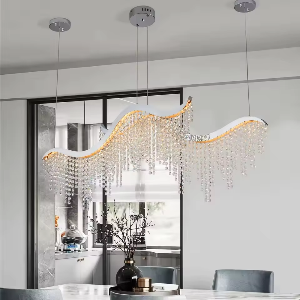 This is a modern wave-shaped crystal chandelier, with a white wave-shaped frame and multi-layer transparent crystal pendants, brilliant lighting, featuring a luxurious and grand design with strong visual appeal. It is used for space lighting and decoration, creating a high-end luxury atmosphere. It is suitable for high-end restaurants, luxury-style home living rooms, luxury clubs and other places.