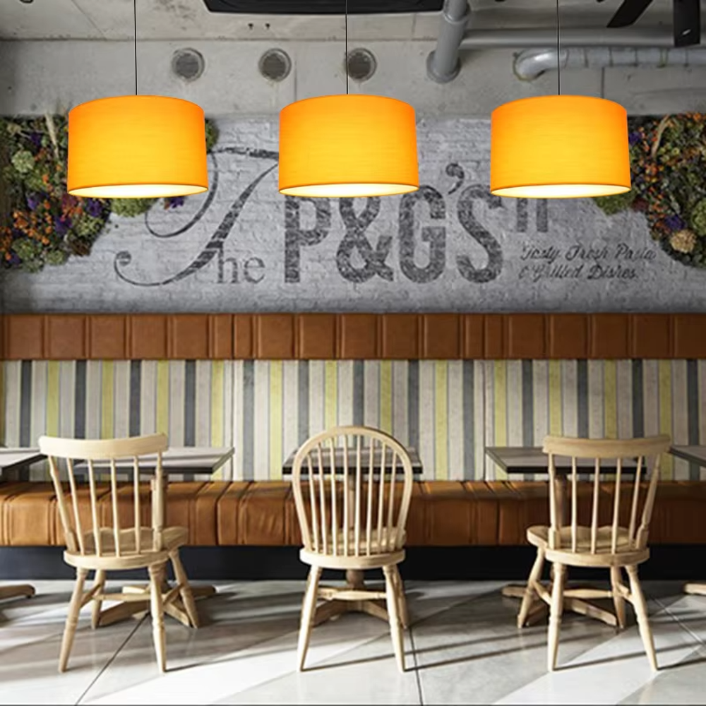 Minimalist beige fabric cylindrical hanging chandelier, metal suspension rod + fabric lampshade, soft and uniform lighting, creating a warm and leisure atmosphere.