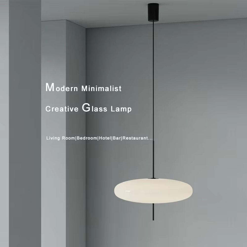 This modern minimalist flat round chandelier features a milky white frosted acrylic lampshade, paired with a thin black suspension rod, transmitting light softly. It serves both lighting and decorative purposes, ideal for modern minimalist spaces such as living rooms, bedrooms, and light luxury restaurants.