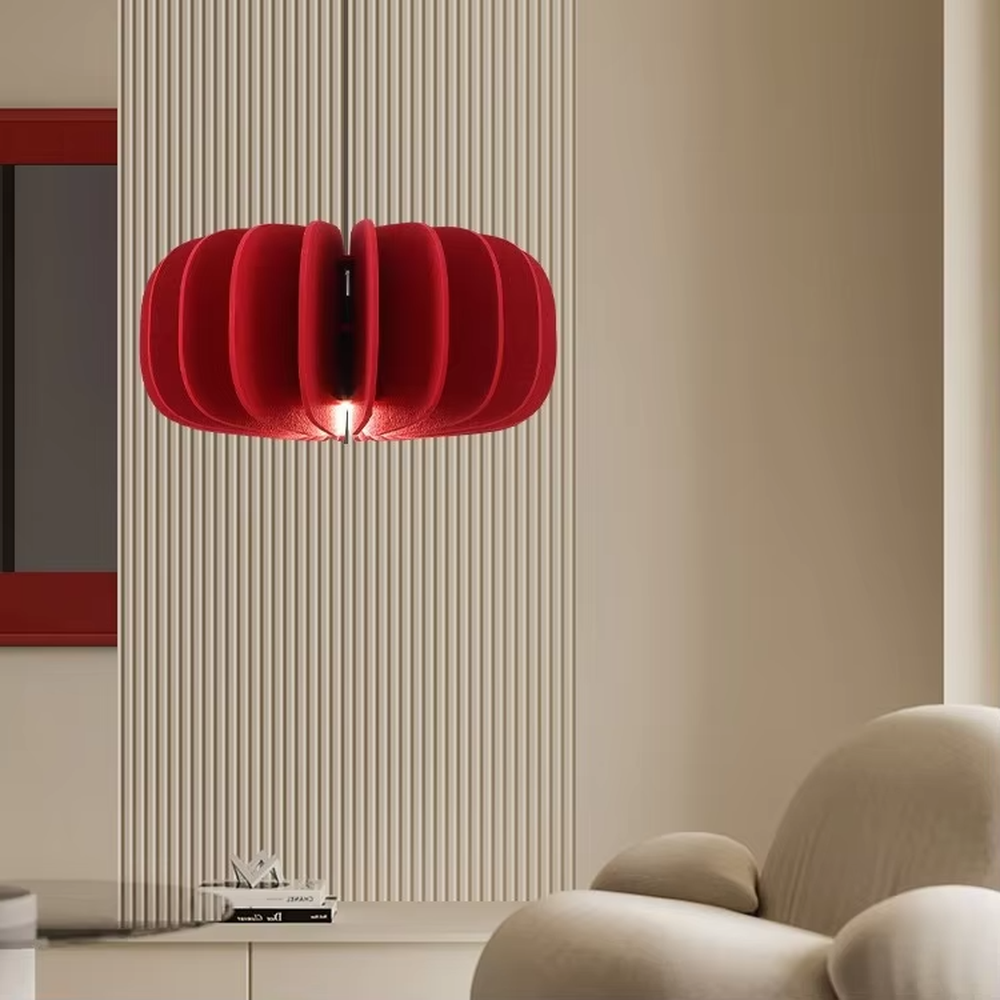 Modern artistic red pleated petal-shaped hanging chandelier, soft fabric material, soft and warm lighting, creating a stylish artistic atmosphere.