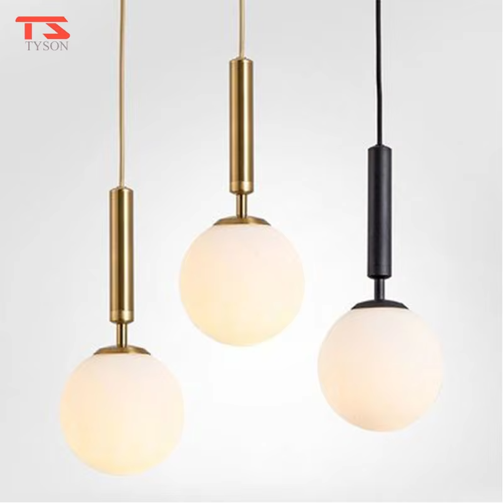 Minimalist gold rod glass ball chandelier (gold cylinder hanging rod + milk-white glass ball), warm light effect, creating a simple and high-end space atmosphere.