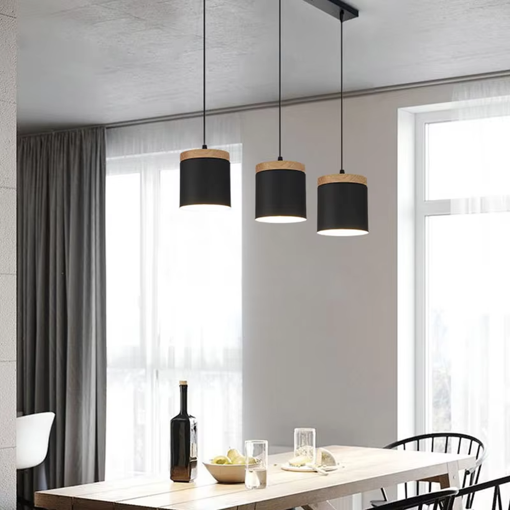 Minimalist black-wood cylindrical double-unit hanging lamp, black cylindrical lampshade + wooden top decoration + thin suspension rope, soft and uniform light, creating a simple natural home atmosphere.