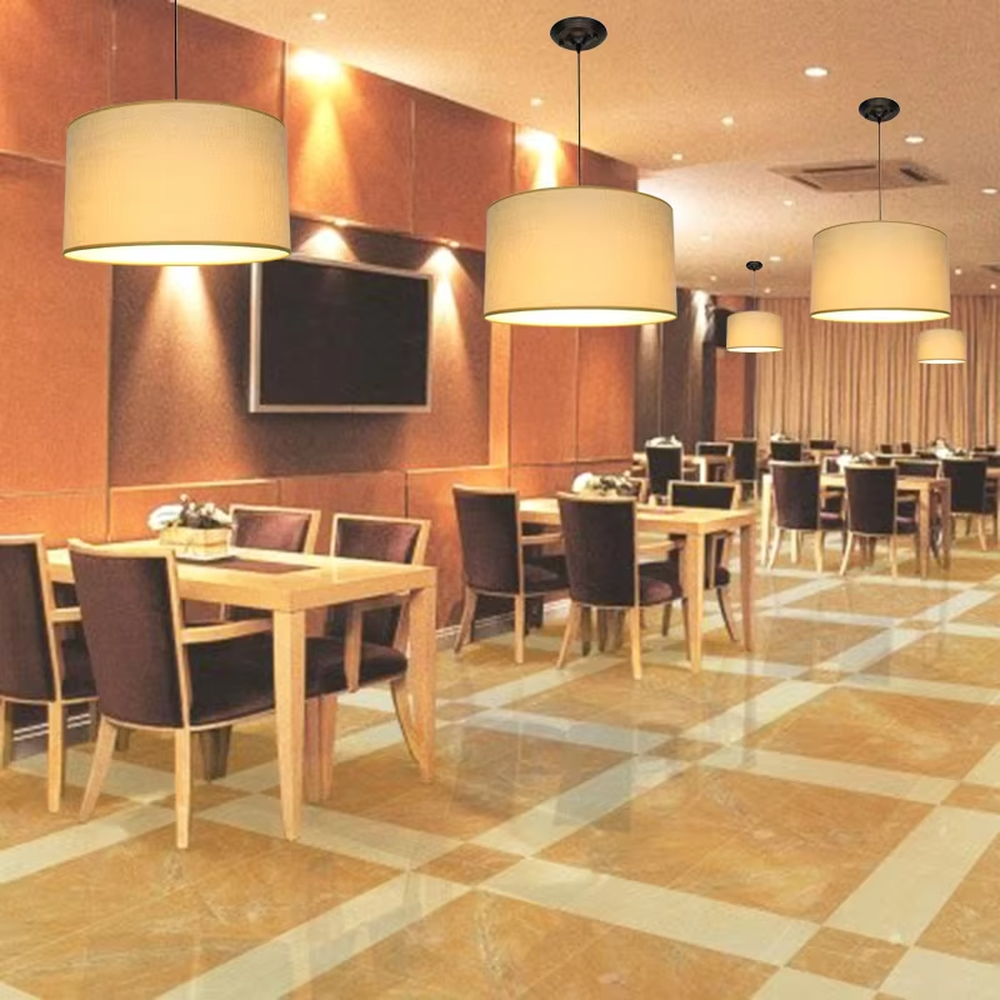 Minimalist beige fabric cylindrical hanging chandelier, metal suspension rod + fabric lampshade, soft and uniform lighting, creating a warm and leisure atmosphere.