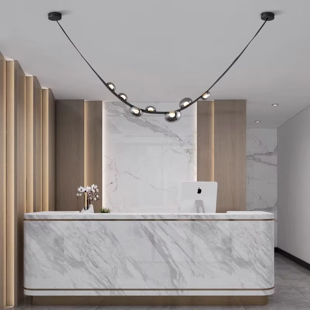 Modern creative curved black frame smoked glass ball chandelier, black curved metal bracket + multiple smoked glass spherical lampshades, soft and high-end lighting, creating a minimalist artistic atmosphere.