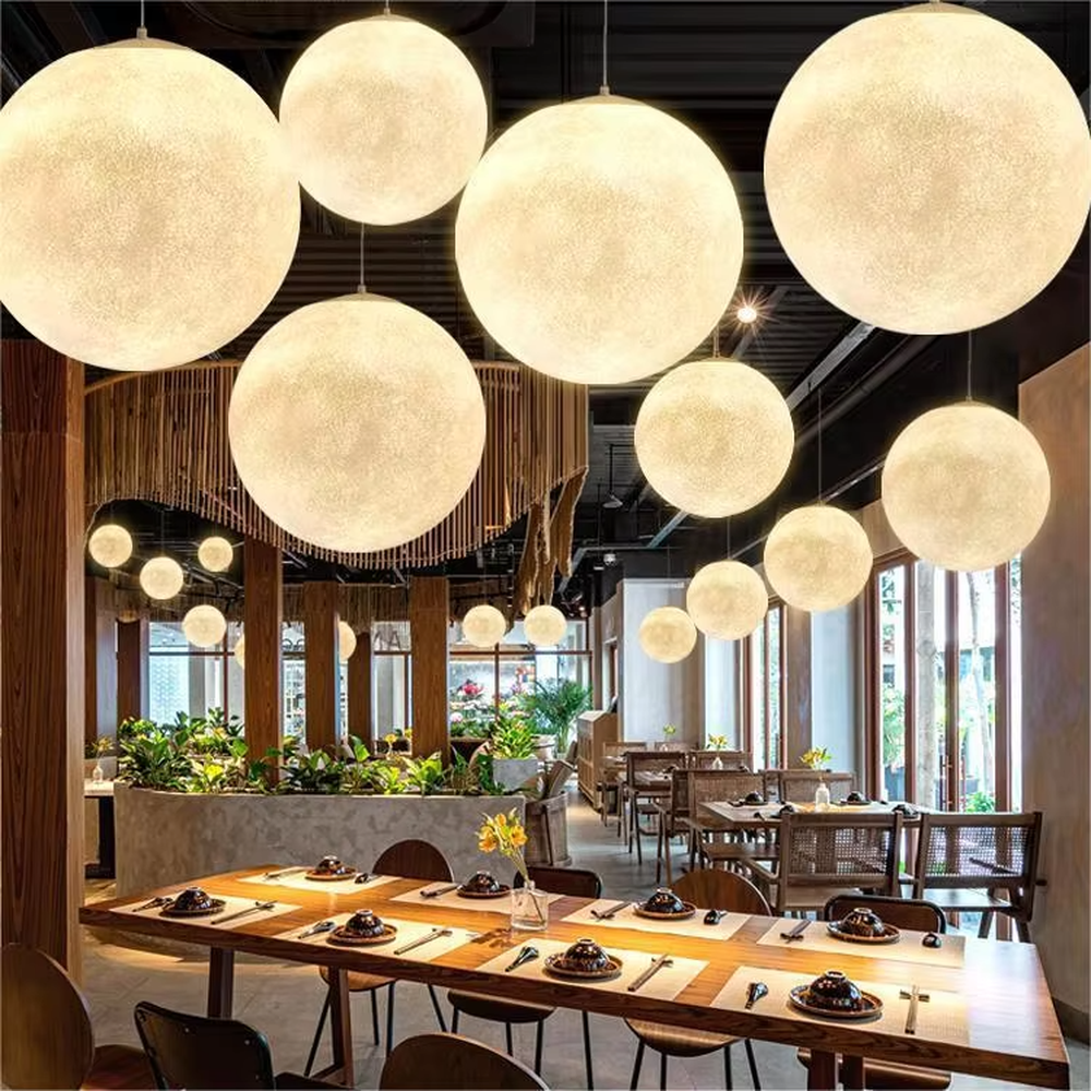 This moon-shaped chandelier simulates lunar surface texture with soft light-transmitting material, hung in varying sizes, serving both lighting and decorative purposes, ideal for Internet celebrity restaurants, cafes, office spaces, exhibition halls and other scenarios.