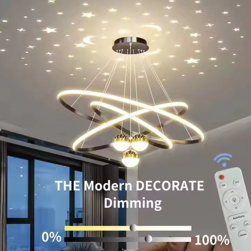 This is a modern creative cross-ring starry sky projection chandelier, with a black frame paired with cross-ring light strips and spherical lamps, and a starry sky (star and moon) projection function. The design is modern and dreamy, with soft lighting and a strong atmosphere. It is used for space lighting and atmosphere creation, suitable for modern-style living rooms, children's rooms, light luxury-style bedrooms and other places.