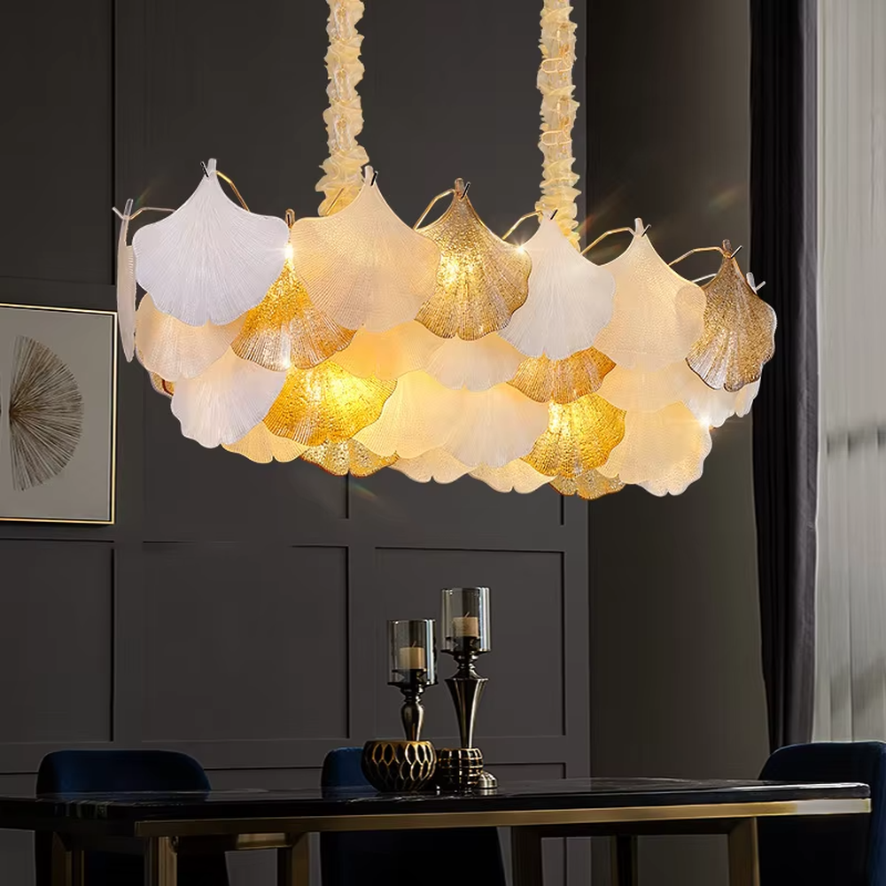 This is an artistic ginkgo leaf-shaped ceiling lamp, featuring gradient (off-white to light gold) textured leaf-shaped lampshades paired with golden metal connectors. The lighting is soft and warm, creating a natural and elegant space atmosphere.