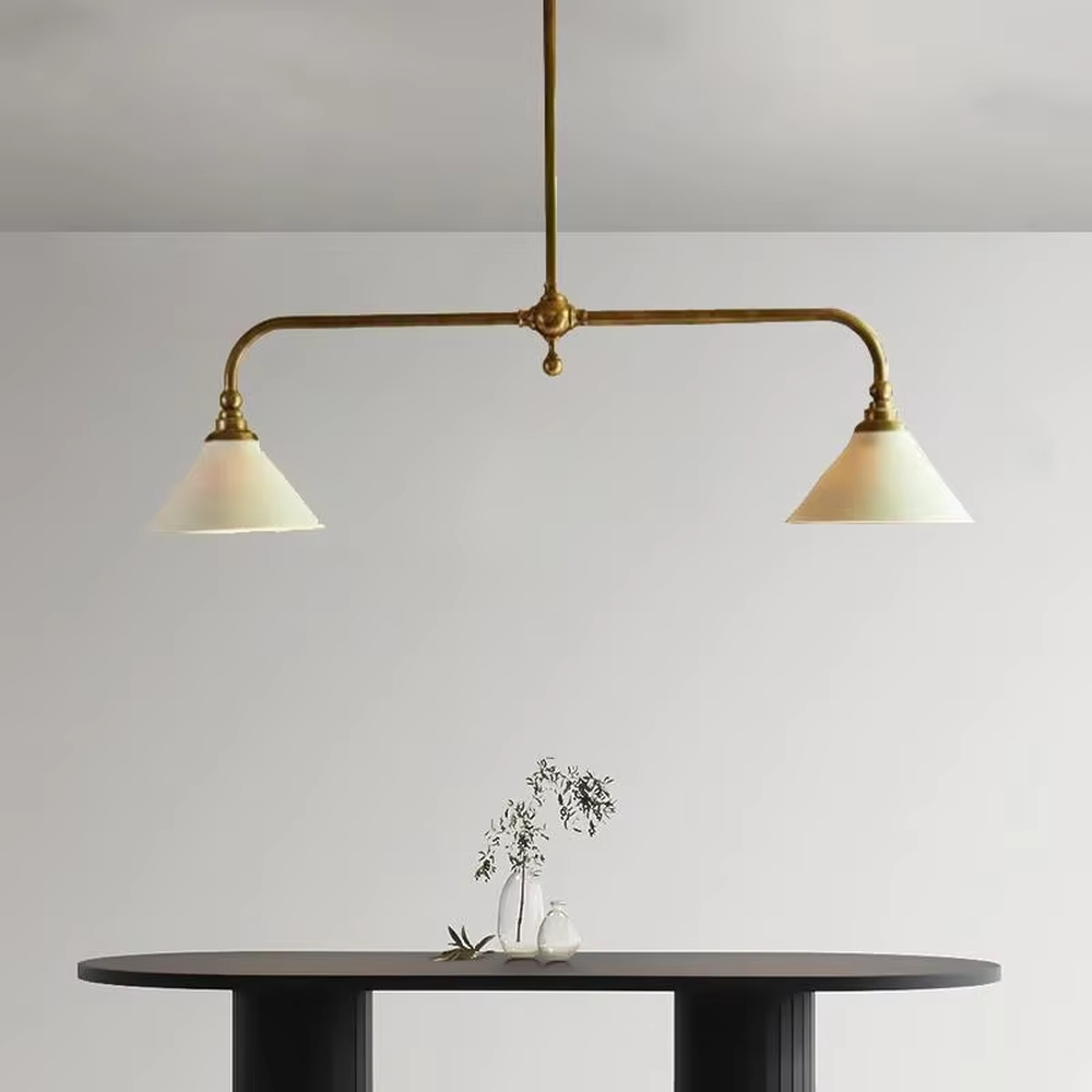 This is a Nordic retro-style double-head chandelier, with a golden metal stand and white conical lampshades, featuring a minimalist retro design and warm texture. It is used for space lighting and decoration, creating a warm retro atmosphere. It is suitable for Nordic-style restaurants, retro-style home living rooms, homestay dining areas and other places.
