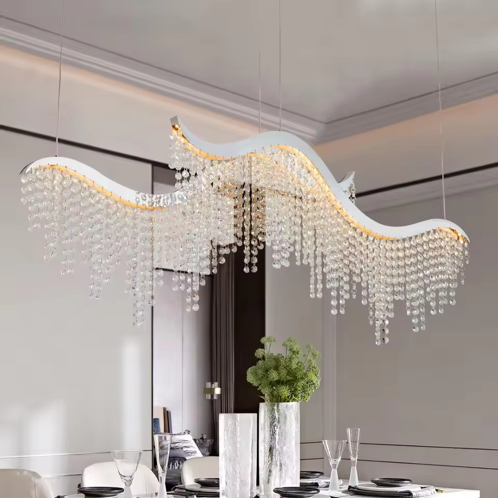This is a modern wave-shaped crystal chandelier, with a white wave-shaped frame and multi-layer transparent crystal pendants, brilliant lighting, featuring a luxurious and grand design with strong visual appeal. It is used for space lighting and decoration, creating a high-end luxury atmosphere. It is suitable for high-end restaurants, luxury-style home living rooms, luxury clubs and other places.