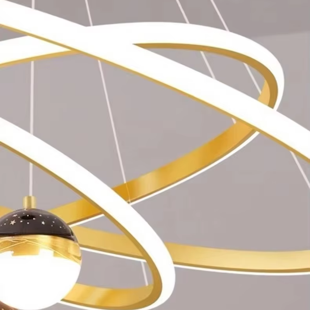 This is a modern creative cross-ring starry sky projection chandelier, with a black frame paired with cross-ring light strips and spherical lamps, and a starry sky (star and moon) projection function. The design is modern and dreamy, with soft lighting and a strong atmosphere. It is used for space lighting and atmosphere creation, suitable for modern-style living rooms, children's rooms, light luxury-style bedrooms and other places.