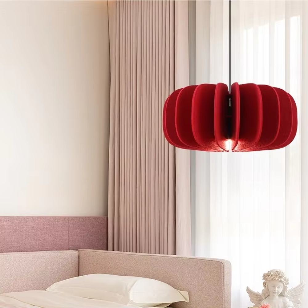Modern artistic red pleated petal-shaped hanging chandelier, soft fabric material, soft and warm lighting, creating a stylish artistic atmosphere.
