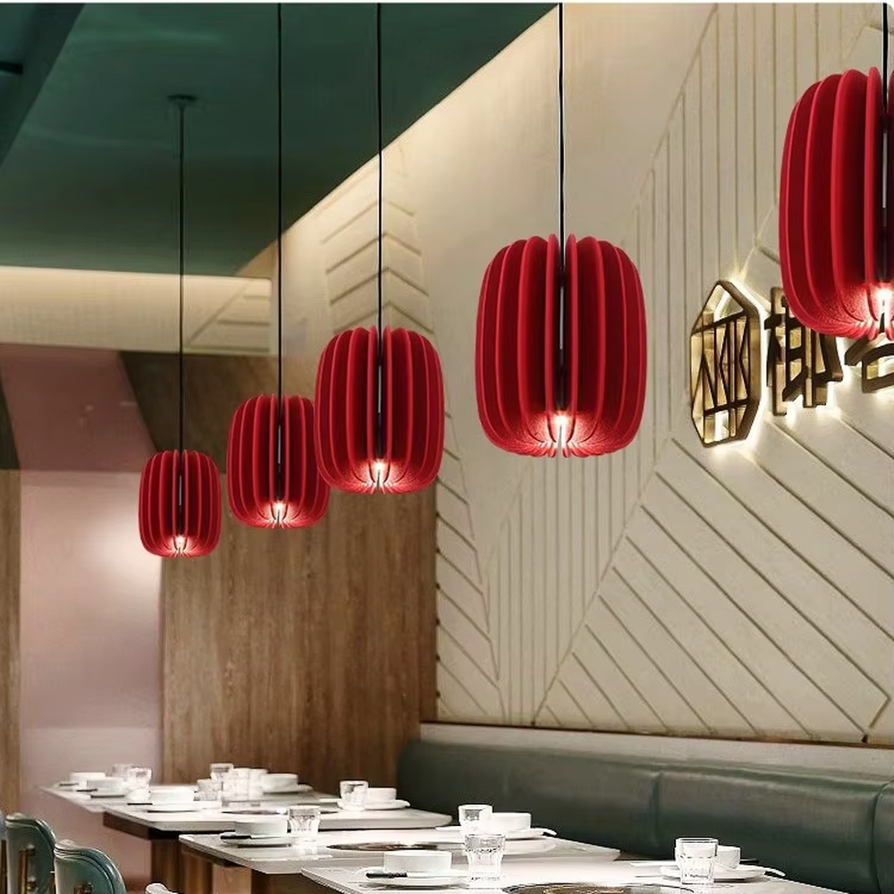 Modern artistic red pleated petal-shaped hanging chandelier, soft fabric material, soft and warm lighting, creating a stylish artistic atmosphere.