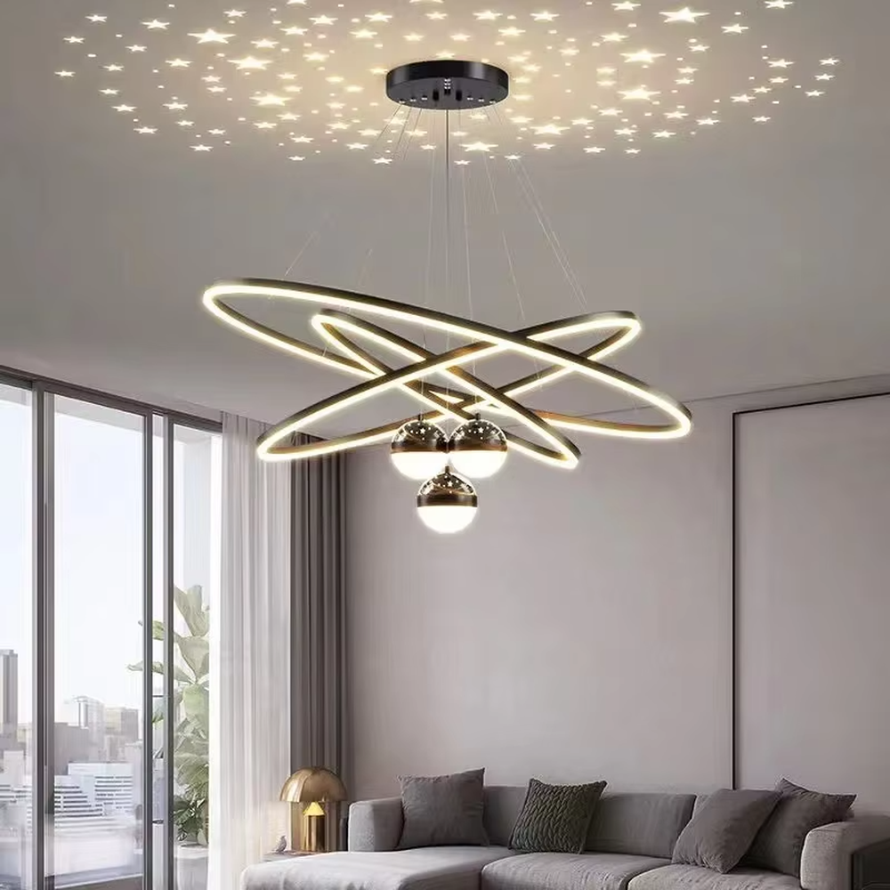 This modern light luxury galaxy-shaped chandelier features multi-layer interlaced ring light strips made of black and gold metal, paired with spherical crystal lamp shades, and has a built-in star and moon projection effect on the top. It serves both lighting and decorative purposes, ideal for modern home spaces such as living rooms and dining rooms, as well as light luxury commercial venues.
