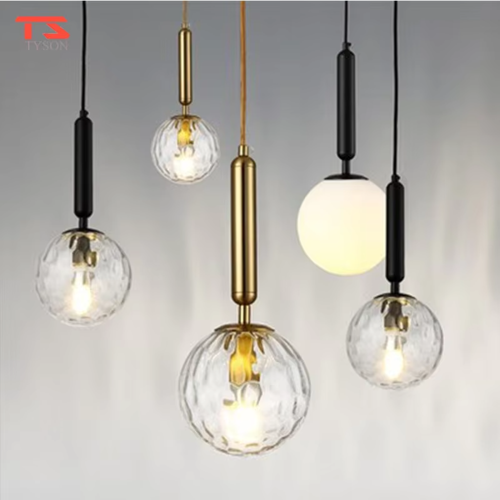 Minimalist gold rod glass ball chandelier (gold cylinder hanging rod + milk-white glass ball), warm light effect, creating a simple and high-end space atmosphere.